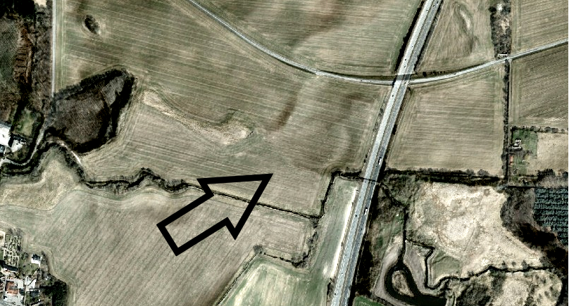 Foto via satélite do anel Borgring. A seta aponta para a forma circular, comum nas fortalezas vikings