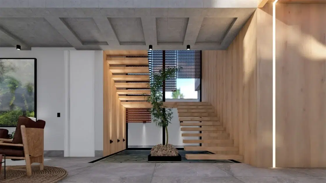 Escada flutuante de madeira em uma casa com iluminação no teto e uma planta no meio.