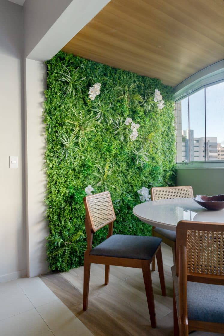 Sala de jantar iluminada com jardim vertical