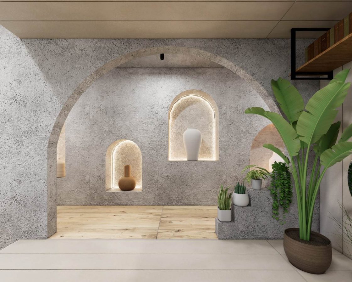 Ambiente com arco de concreto, piso de madeira e vasos de plantas
