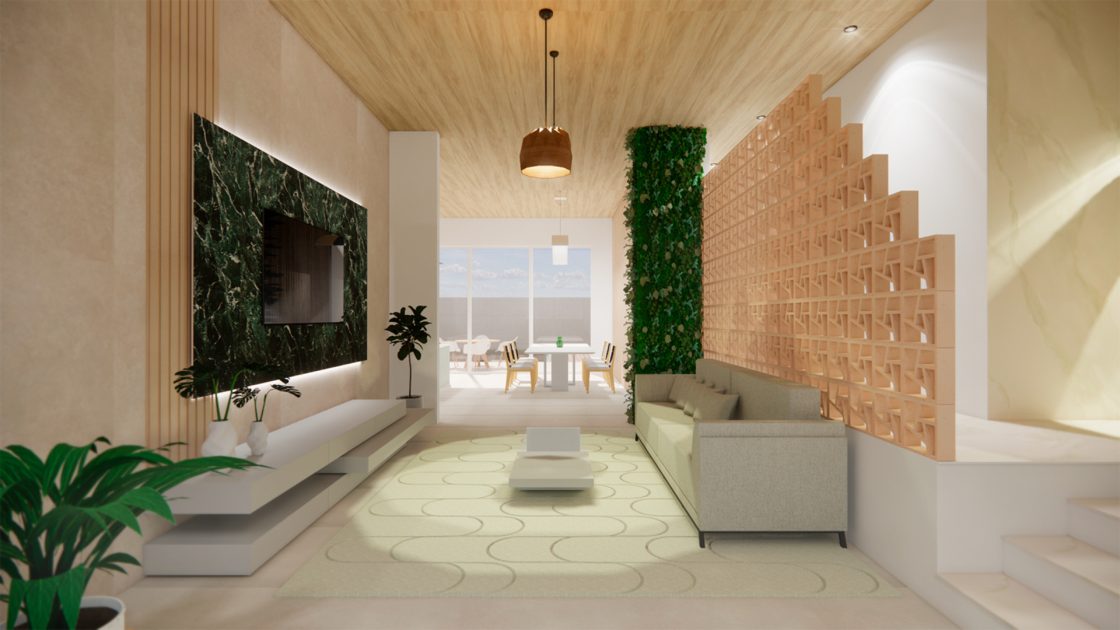 Sala com parede verde, cobogós e grandes aberturas que permitem ventilação e iluminação de forma passiva