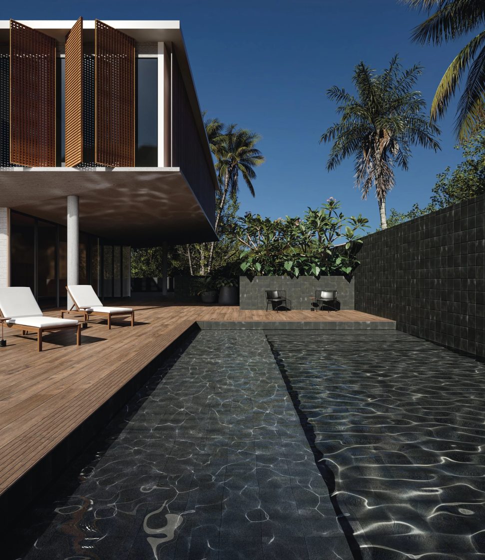 Área externa com espreguiçadeiras, plantas e piscina com revestimento cinza-escuro