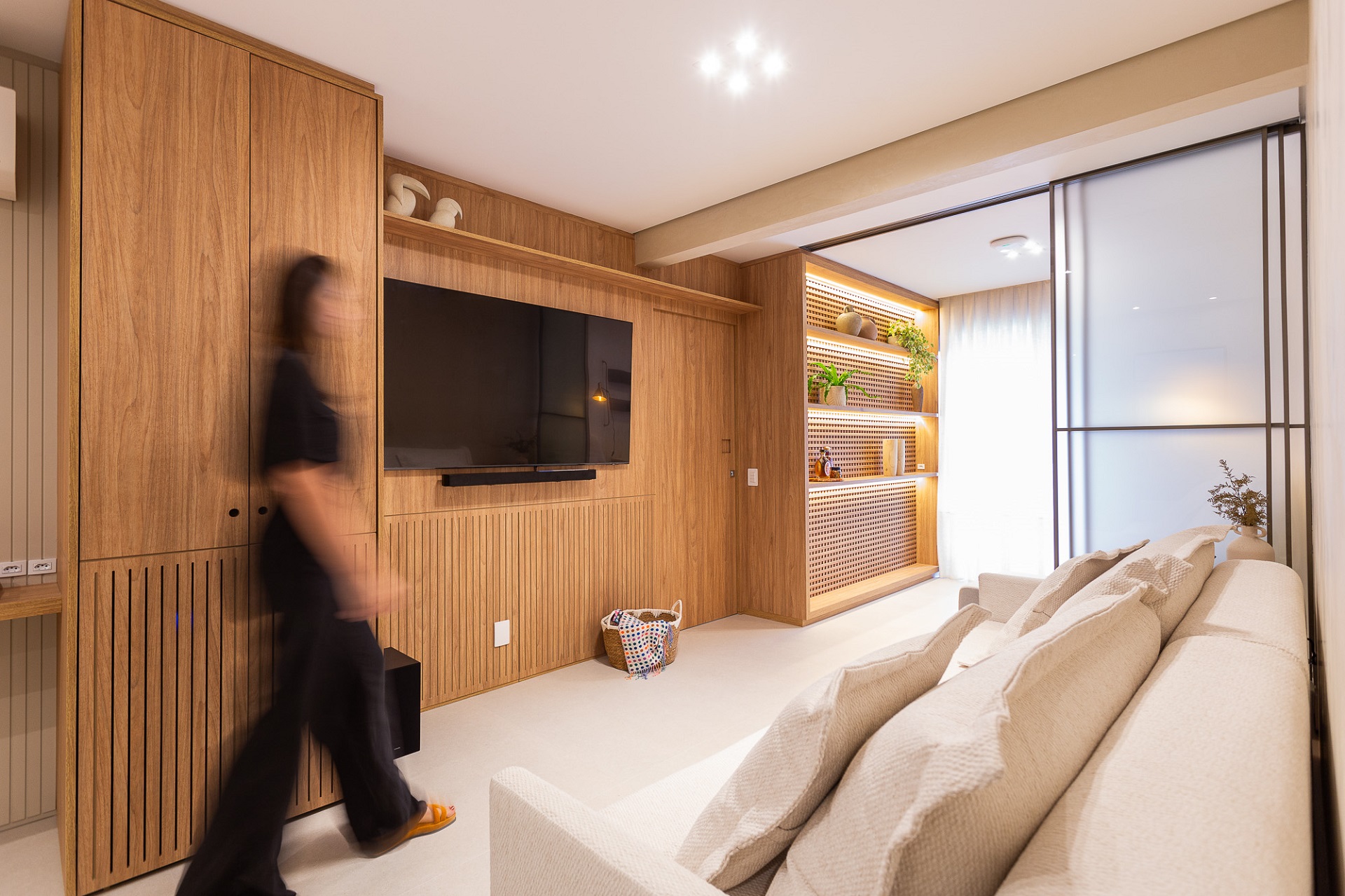 Sala em apartamento pequeno com tons terrosos e detalhes em madeira