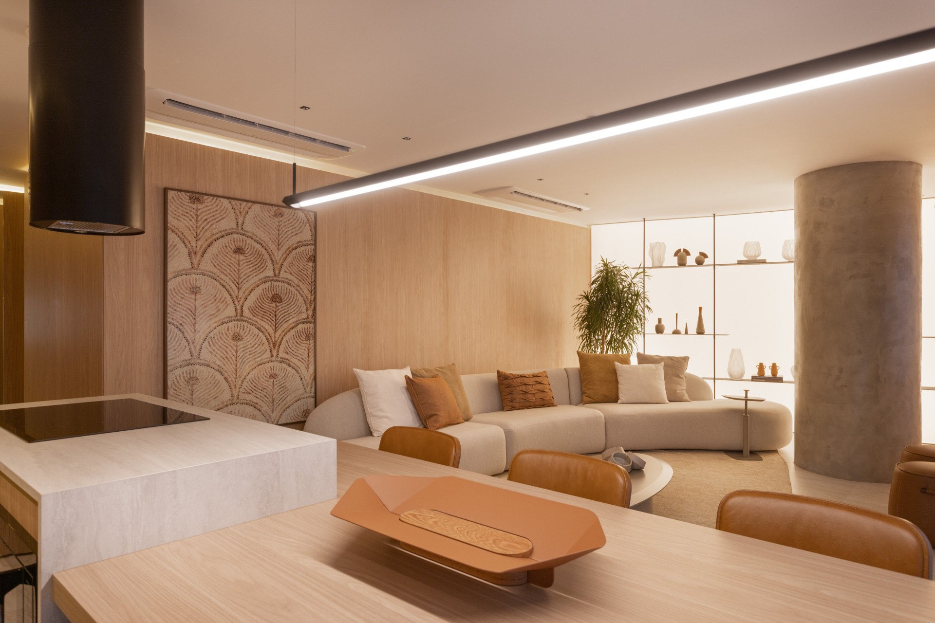 Cozinha e sala de estar integradas, em tons terrosos e estilo contemporâneo