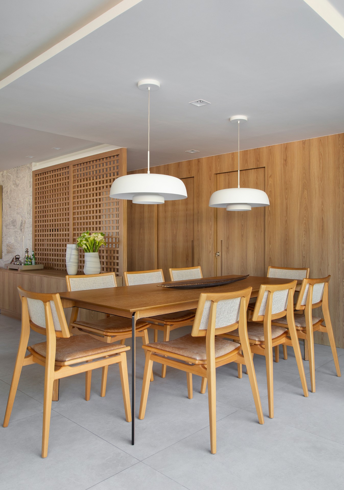 Sala de jantar com tons amadeirados e palha indiana