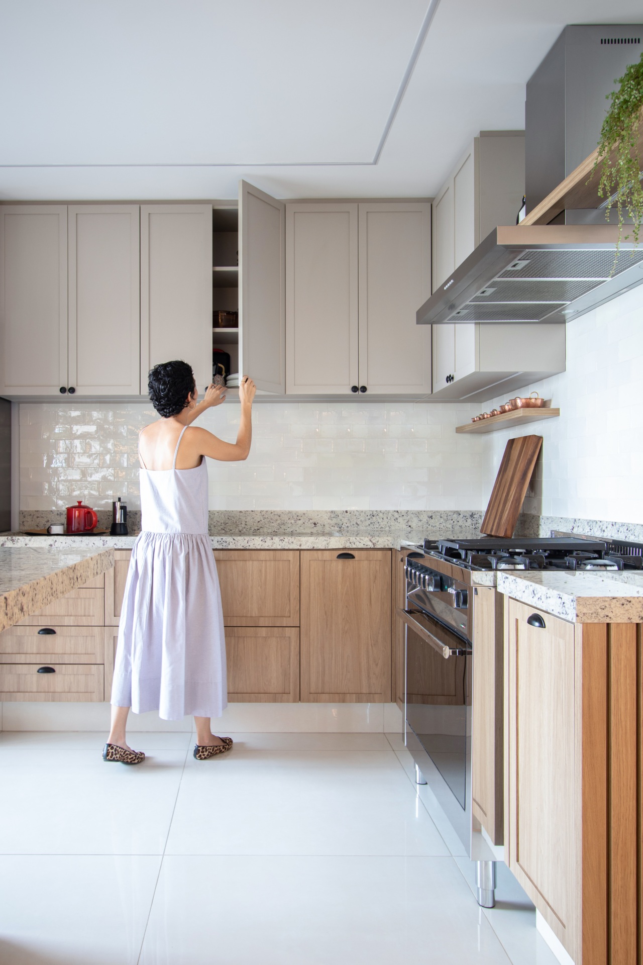 Mulher abre armário de cozinha