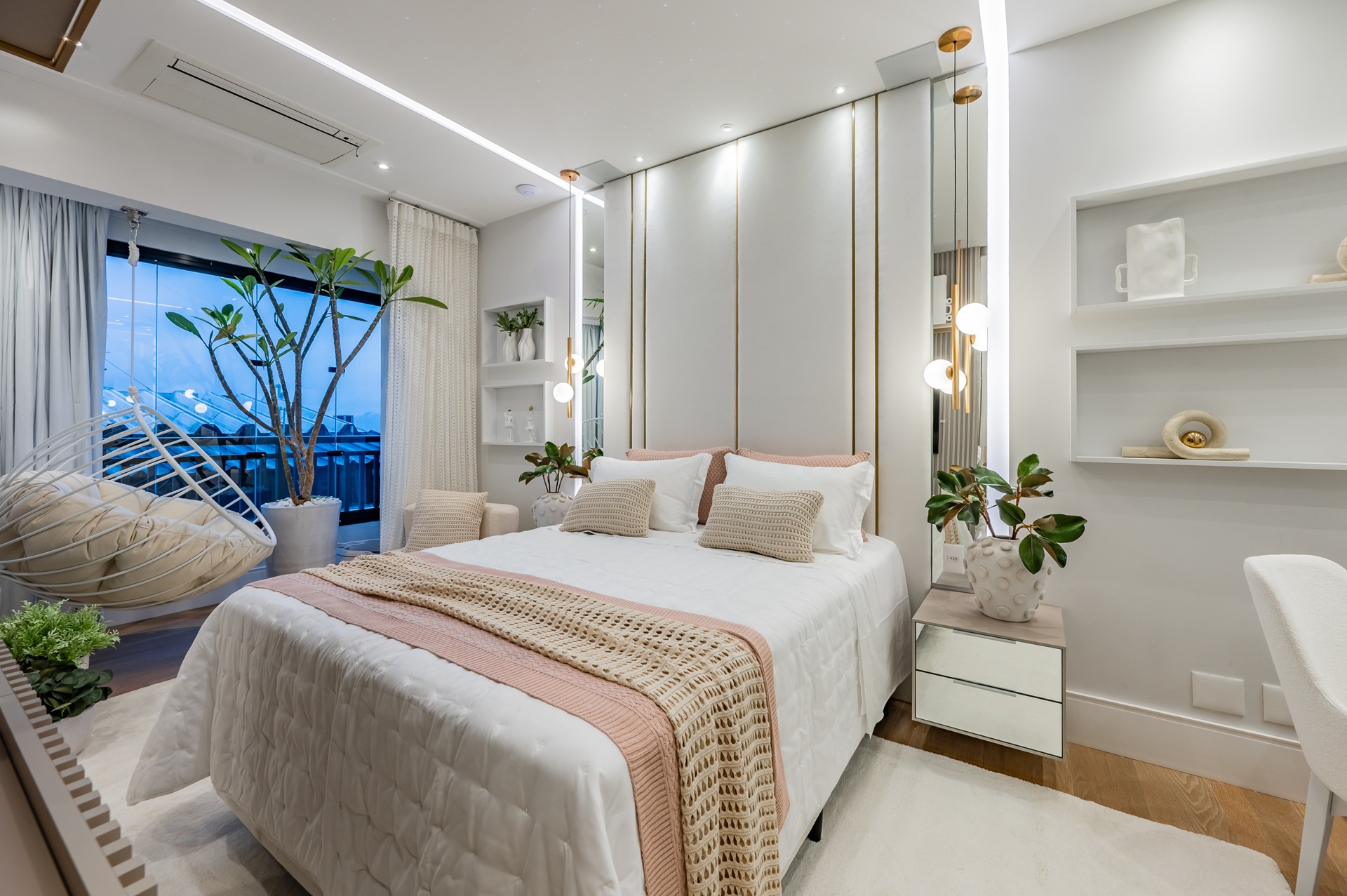 Quarto em tons neutros e com detalhes rosados na roupa de cama