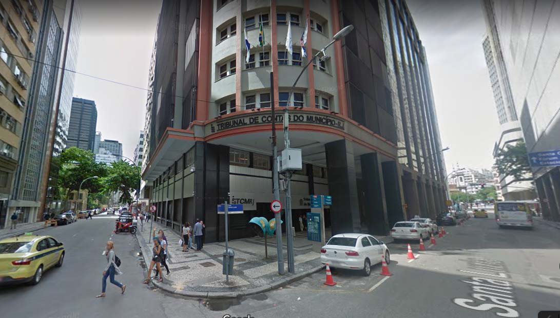 machado de assis rota Vista do edifício do Tribunal de Contas do Município do Rio de Janeiro, com fachada em tons claros e colunas que sustentam a parte superior