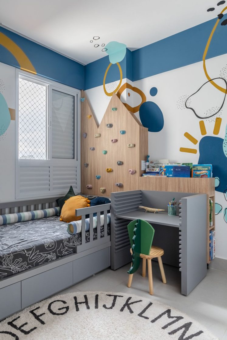 Quarto infantil de menino com pintura azul e branca com detalhes amarelos nas paredes e marcenaria cinza