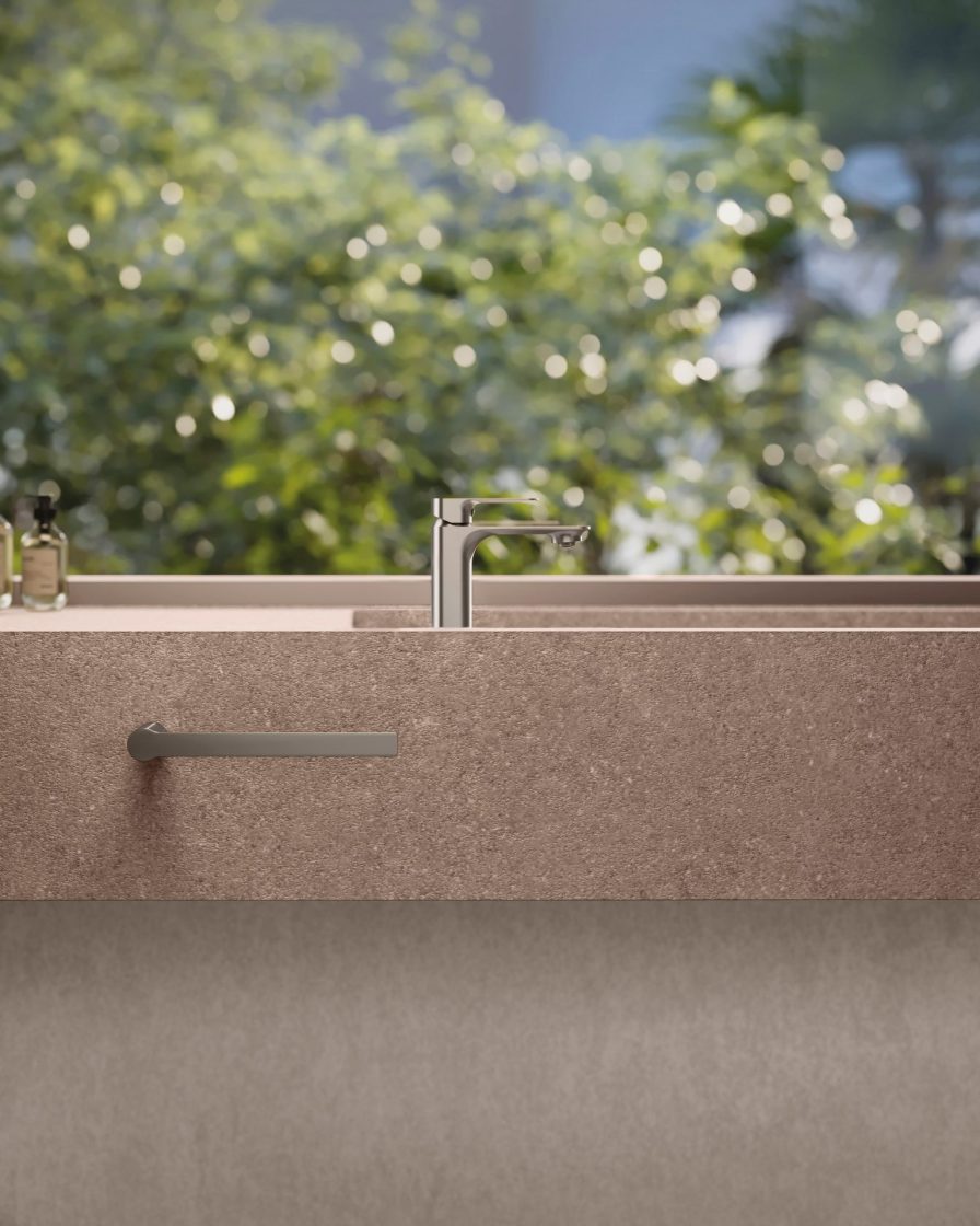 Bancada de banheiro em porcelanato bege com torneira de sobrepor do tipo monocomando e porta-toalha de rosto, ambos na cor níquel